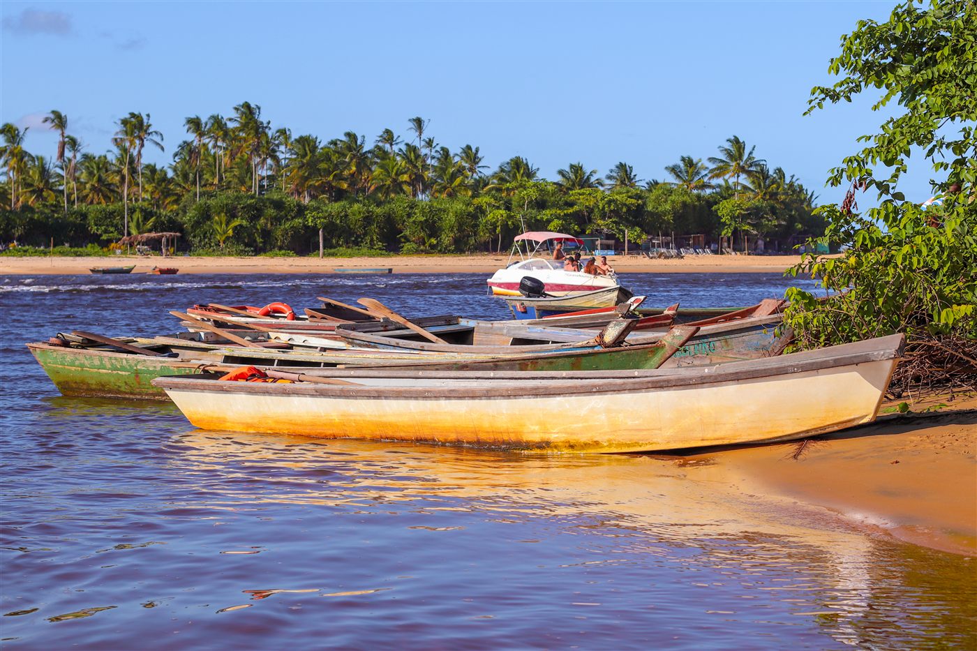 Canoas na margem do rio ao entardecer em Caraíva